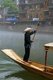 China: Boatman early morning on Fenghuang's misty Tuo River, Fenghuang, Hunan Province