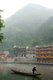 China: Boatman early morning on Fenghuang's misty Tuo River, Fenghuang, Hunan Province